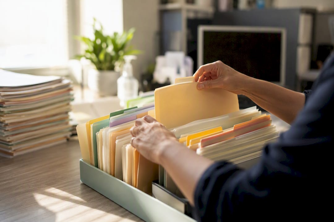 hands sorting healthcare claim files